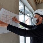 What Does a General Contractor Actually Do - contractor hard hat blueprint.